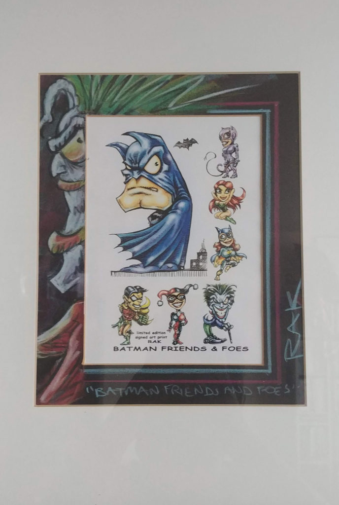 framed caricatures of batman, catwoma, poison ivy, batgirl, joker, harley quinn, robin